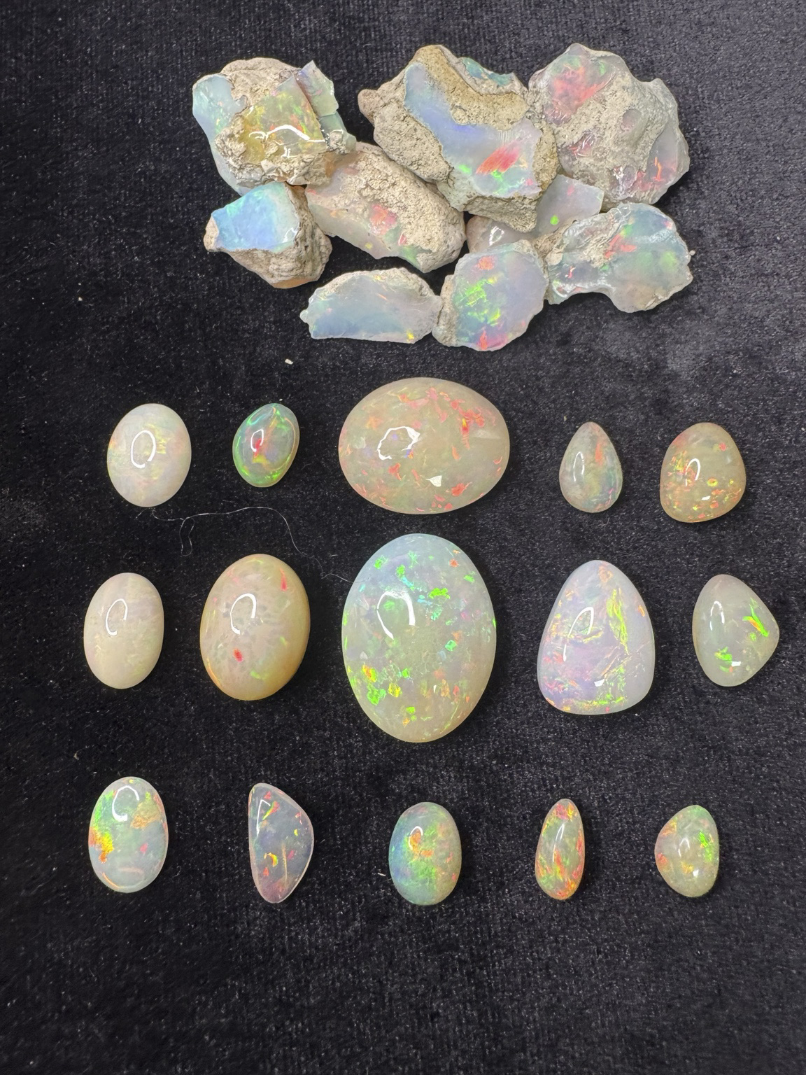 Ethiopian crystal opal shown as rough and finished cabochons