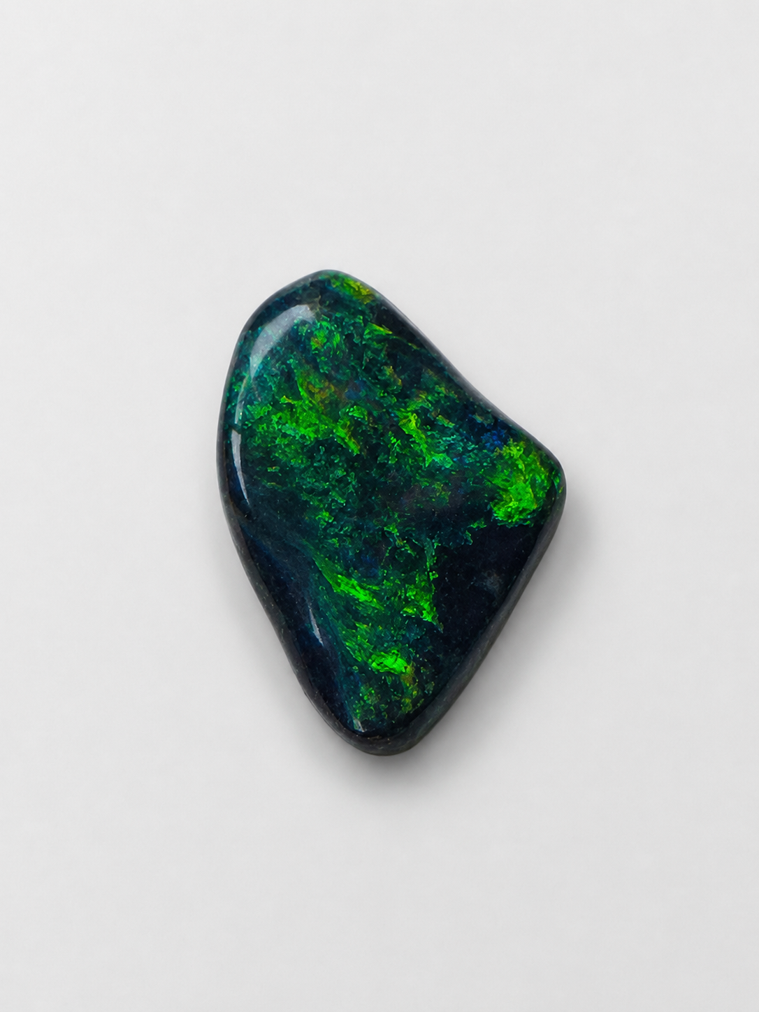Lightning Ridge black opal carved to follow its strongest color
