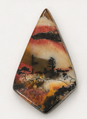 A hand-cut picture stone with dendrites resembling trees in a layered landscape